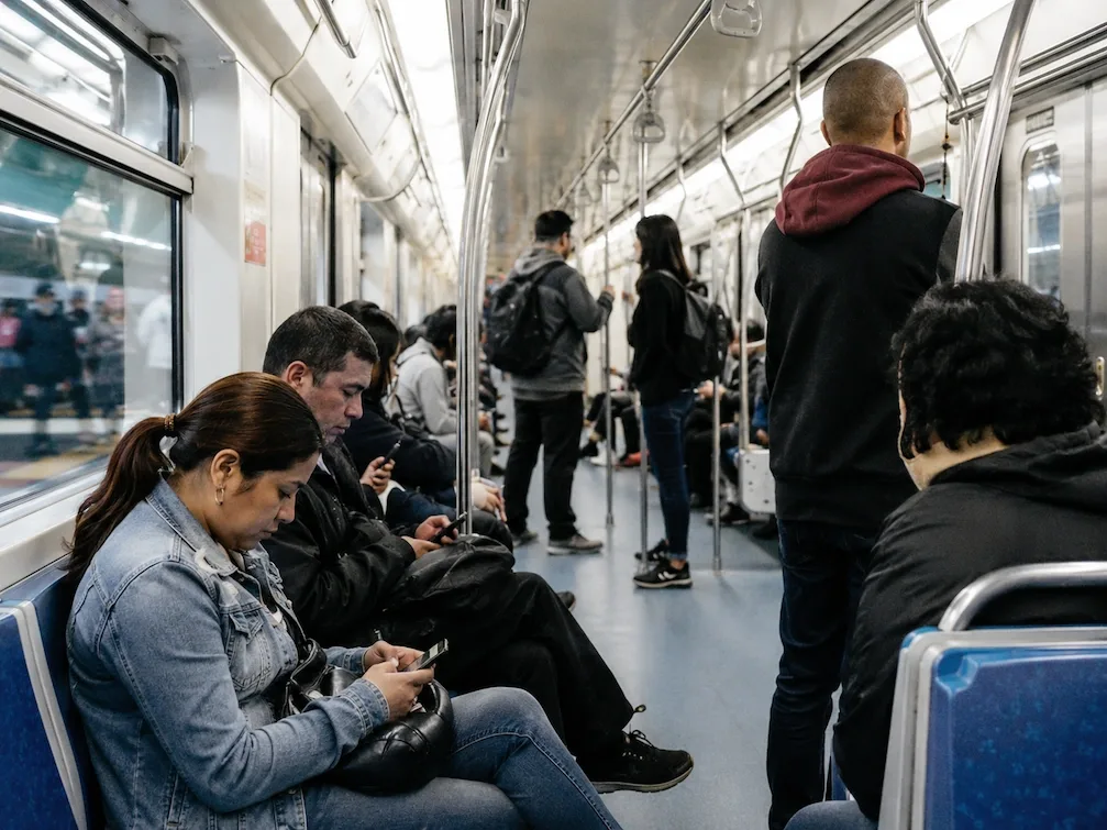 The bright modern interior of a Sao Paulo Metro carriage full of commuters