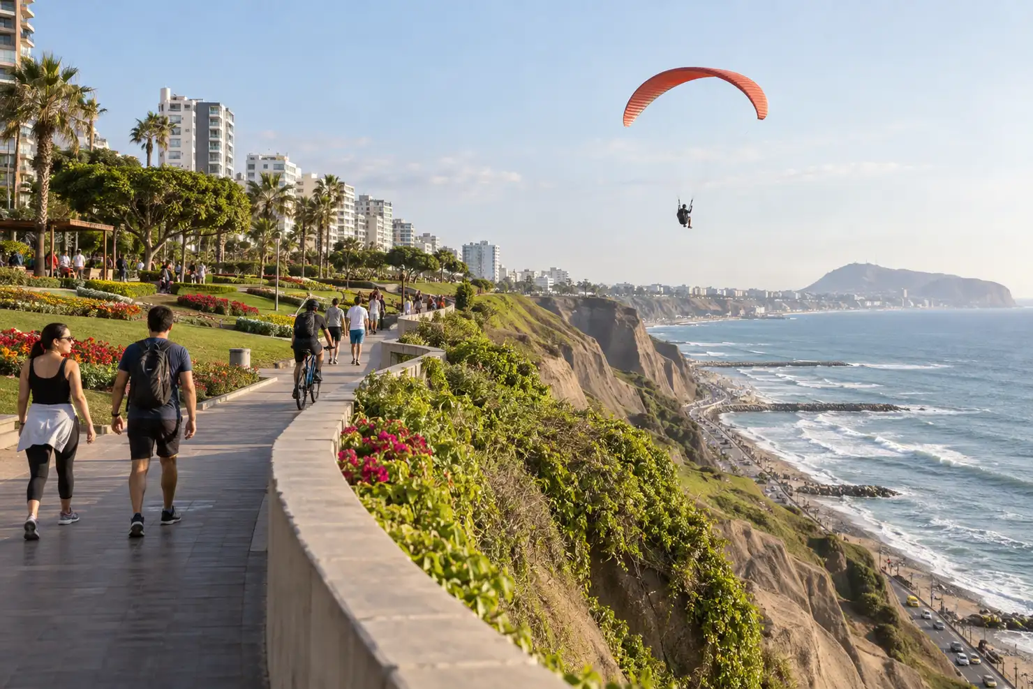 The malecón path between Miraflores and Barranco, a paraglider over the cliff edge, walkers and cyclists below