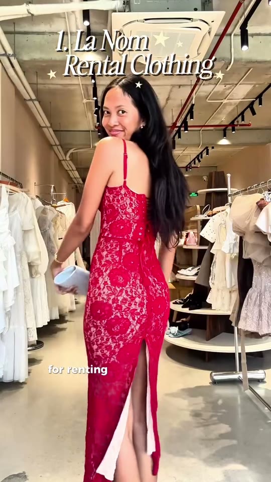 A model in a rented red lace dress poses inside La Nom, a clothing-rental boutique in Da Nang.